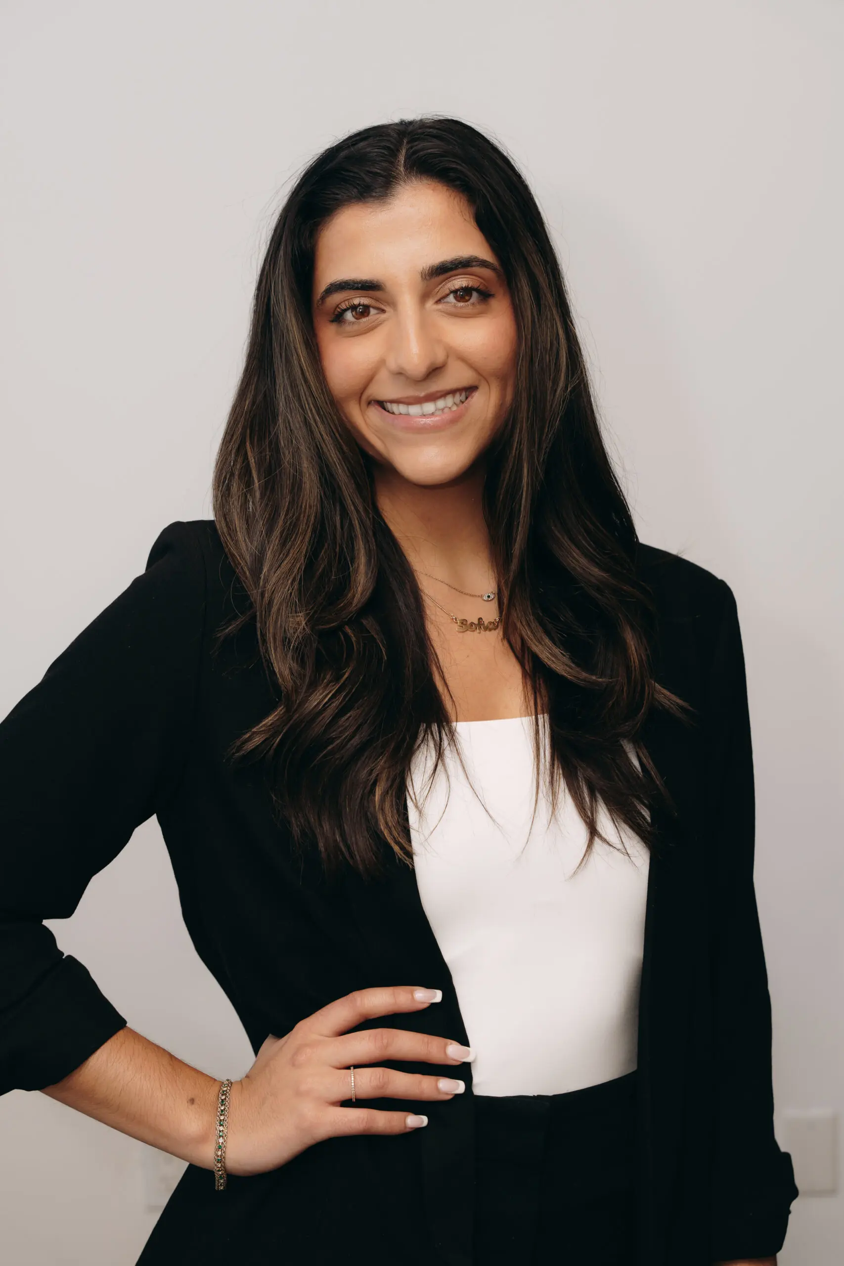 Female attorney headshot wearing a black blazer and white top.