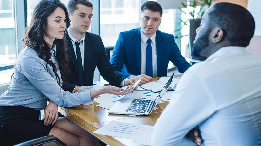 Attorneys reviewing legal documents during a client meeting.