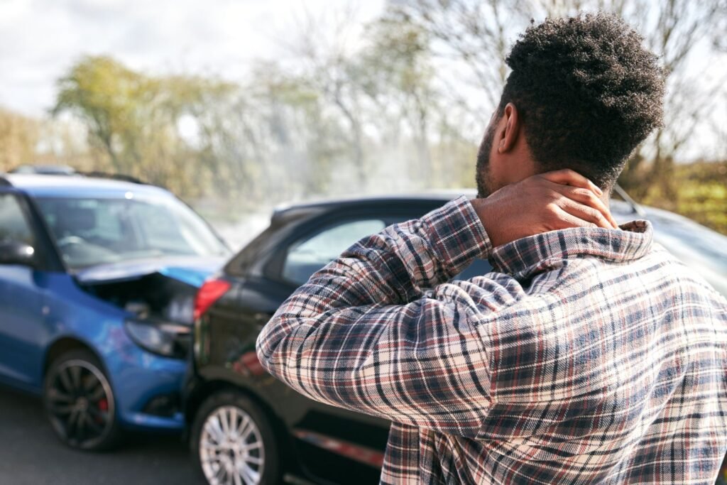 Personal injury accident victim holding neck after a rear-end car crash and seeking legal guidance in Los Angeles