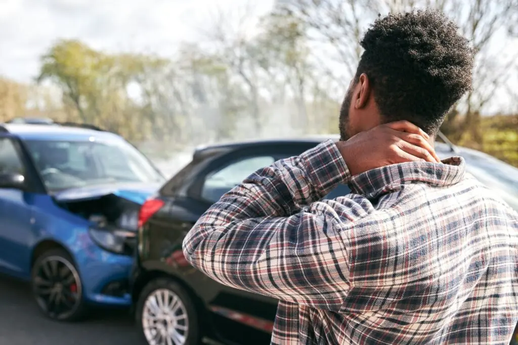 Personal injury accident victim holding neck after a rear-end car crash and seeking legal guidance in Los Angeles
