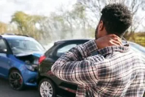 Personal injury accident victim holding neck after a rear-end car crash and seeking legal guidance in Los Angeles
