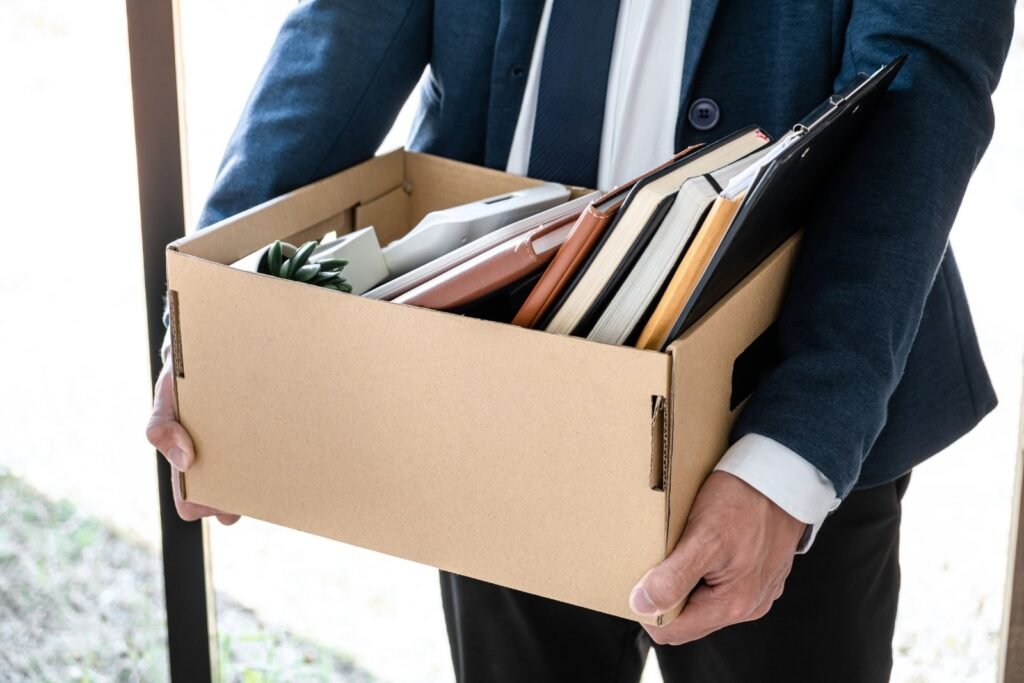 Man holding belongings after being terminated California Wrongful Termination Lawyer Know Your Employee Rights